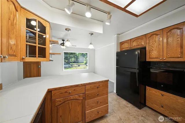a kitchen with stainless steel appliances granite countertop a refrigerator and a stove top oven