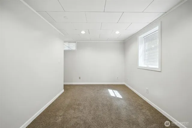 an empty room with a empty space and windows