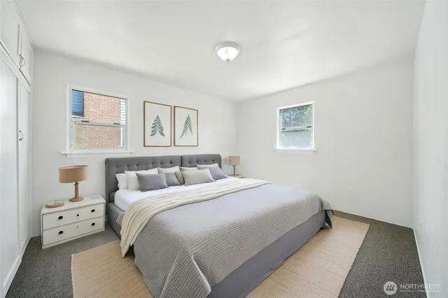 a bedroom with a bed and a night stand