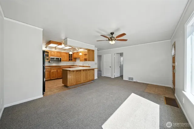 a view of an empty room with a kitchen