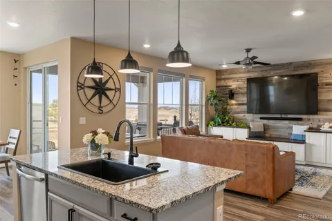 a kitchen with sink and a large window