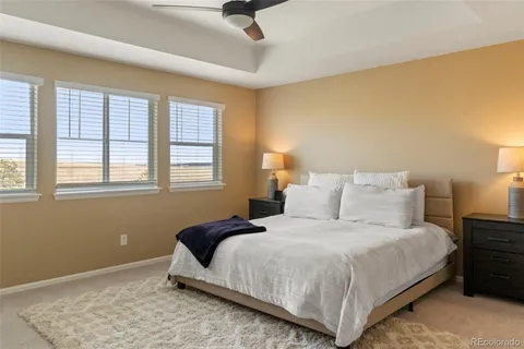 a bedroom with a bed lamp and window