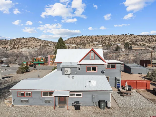 an aerial view of a house with a big yard