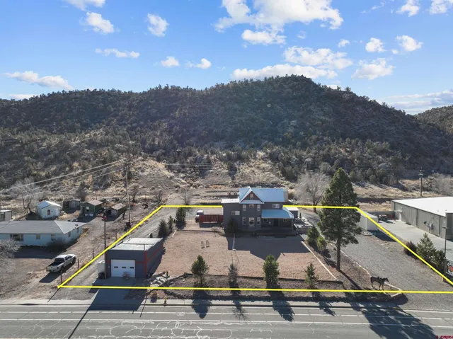 an aerial view of residential houses with outdoor space