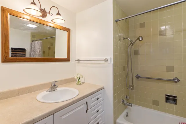 a bedroom with a large bed and a chair