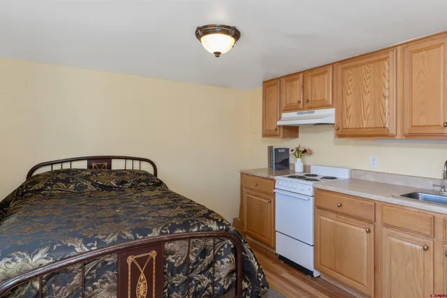 a bedroom with a bed and a painting on the wall