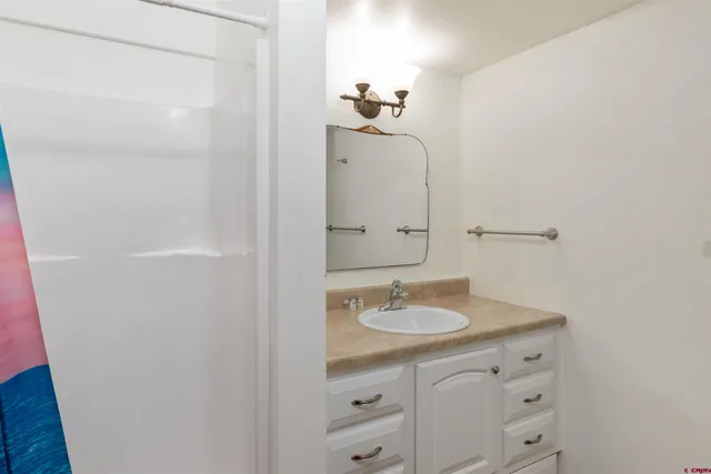 a bathroom with a double vanity sink and mirror