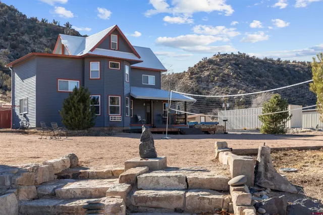 a view of a house with backyard and sitting area