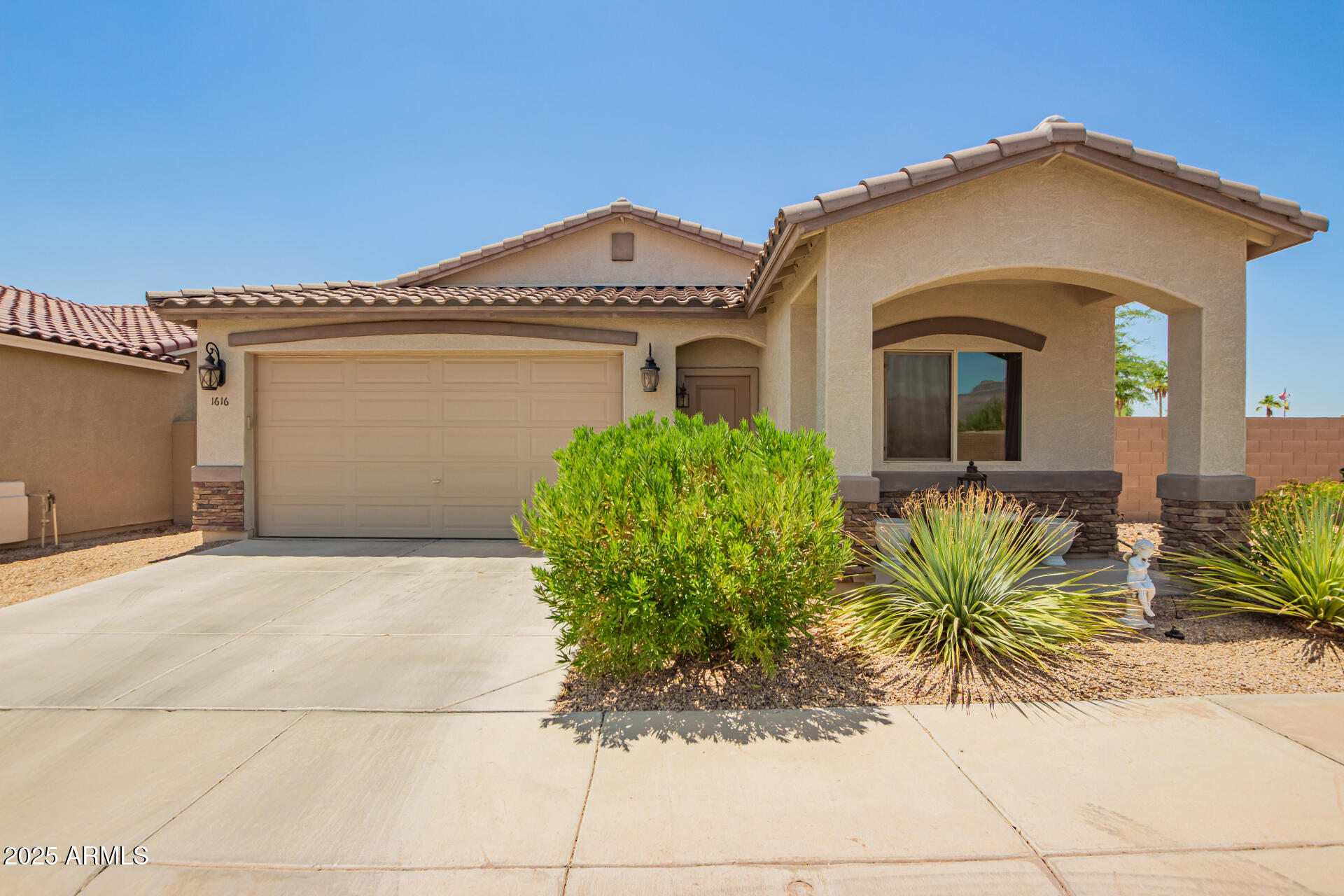 a front view of a house with garden