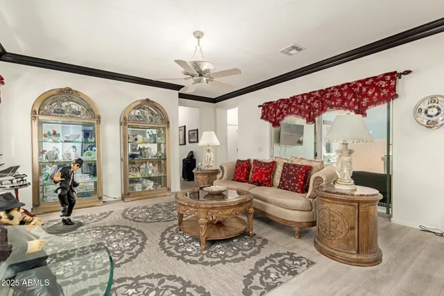 a living room with furniture and a chandelier