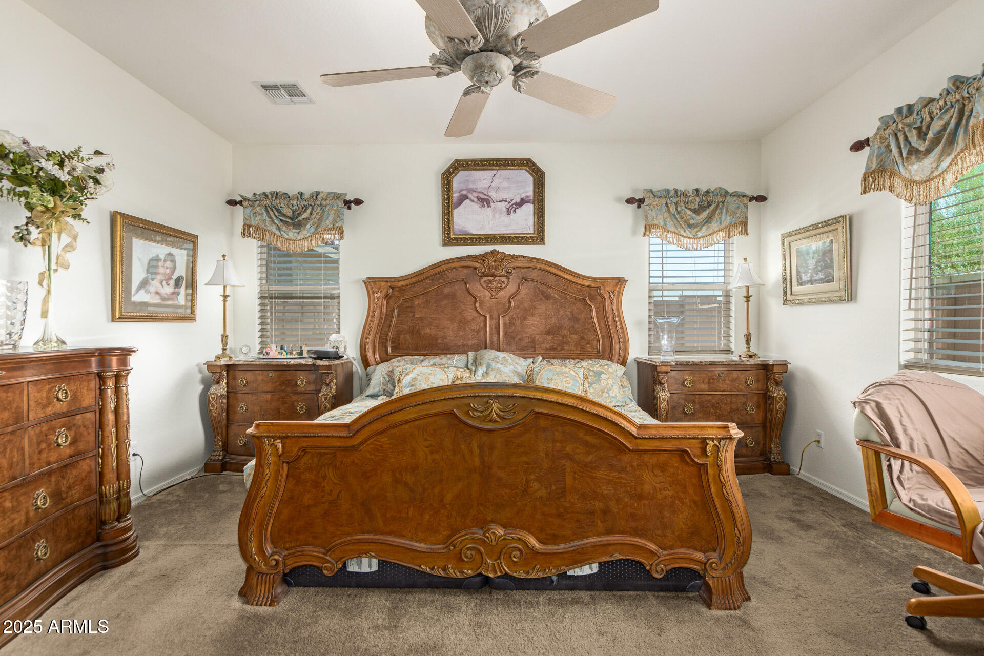 1616 South Aryelle Road Apache Junction, AZ 85119 - Photo 15 of 29 a bedroom with a bed and a chandelier