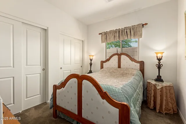 a bedroom with a bed a dresser and book shelf