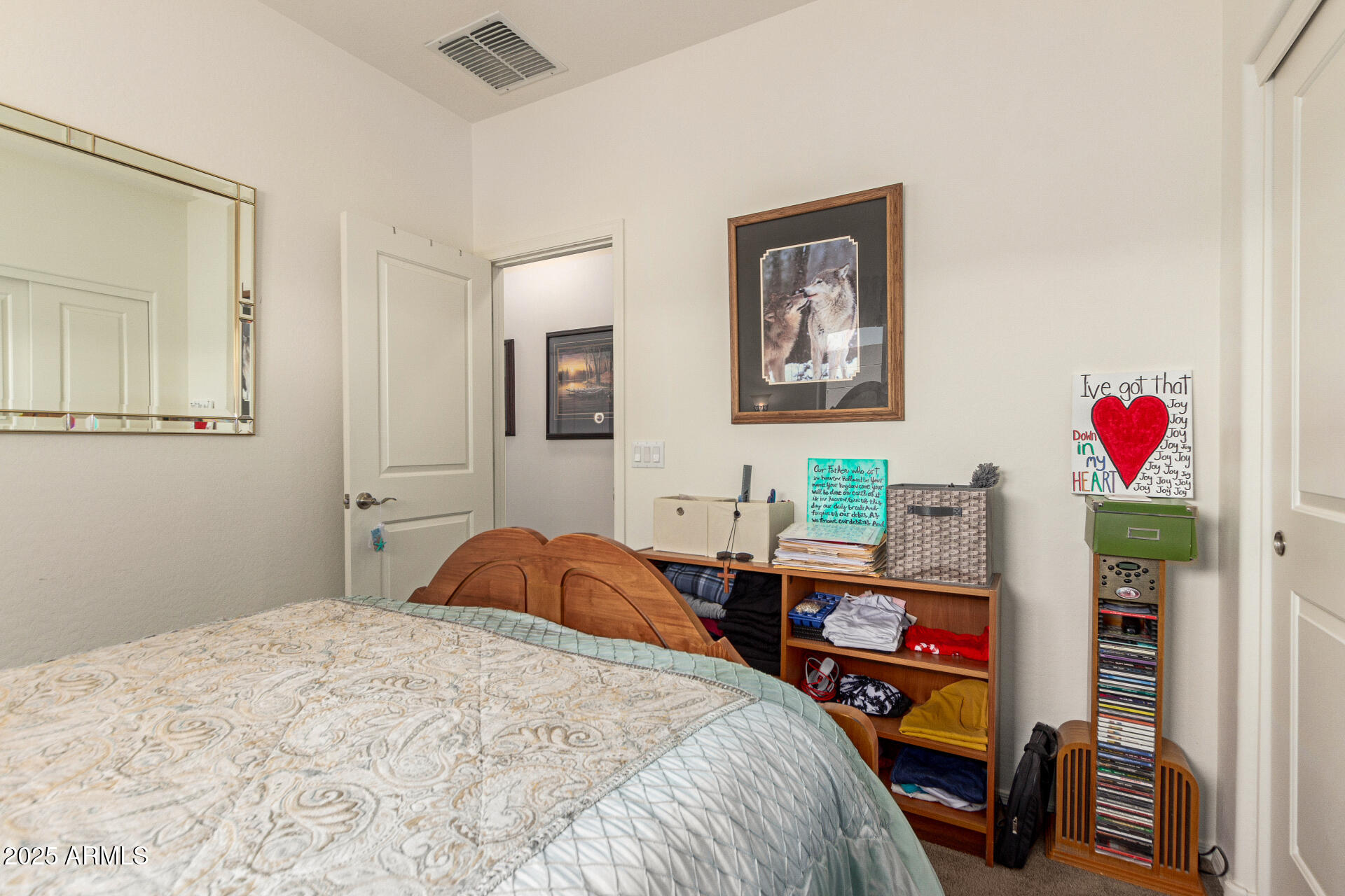1616 South Aryelle Road Apache Junction, AZ 85119 - Photo 21 of 29 a bedroom with a bed a dresser and book shelf