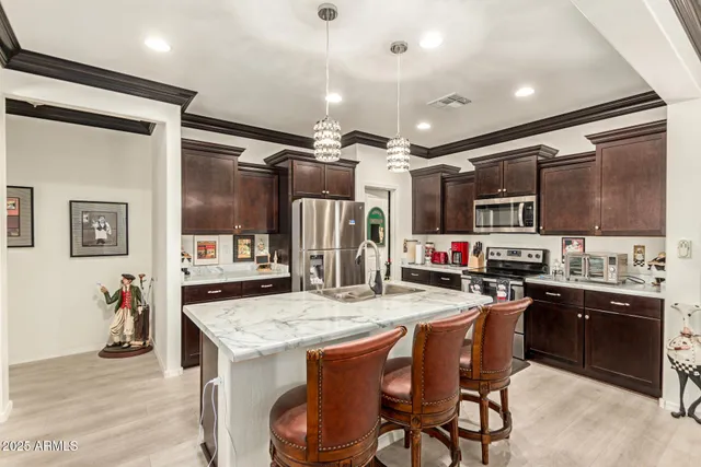 a kitchen with granite countertop a sink appliances and cabinets