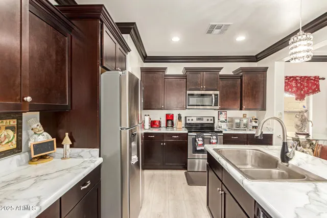 a kitchen that has a sink and a stove in it