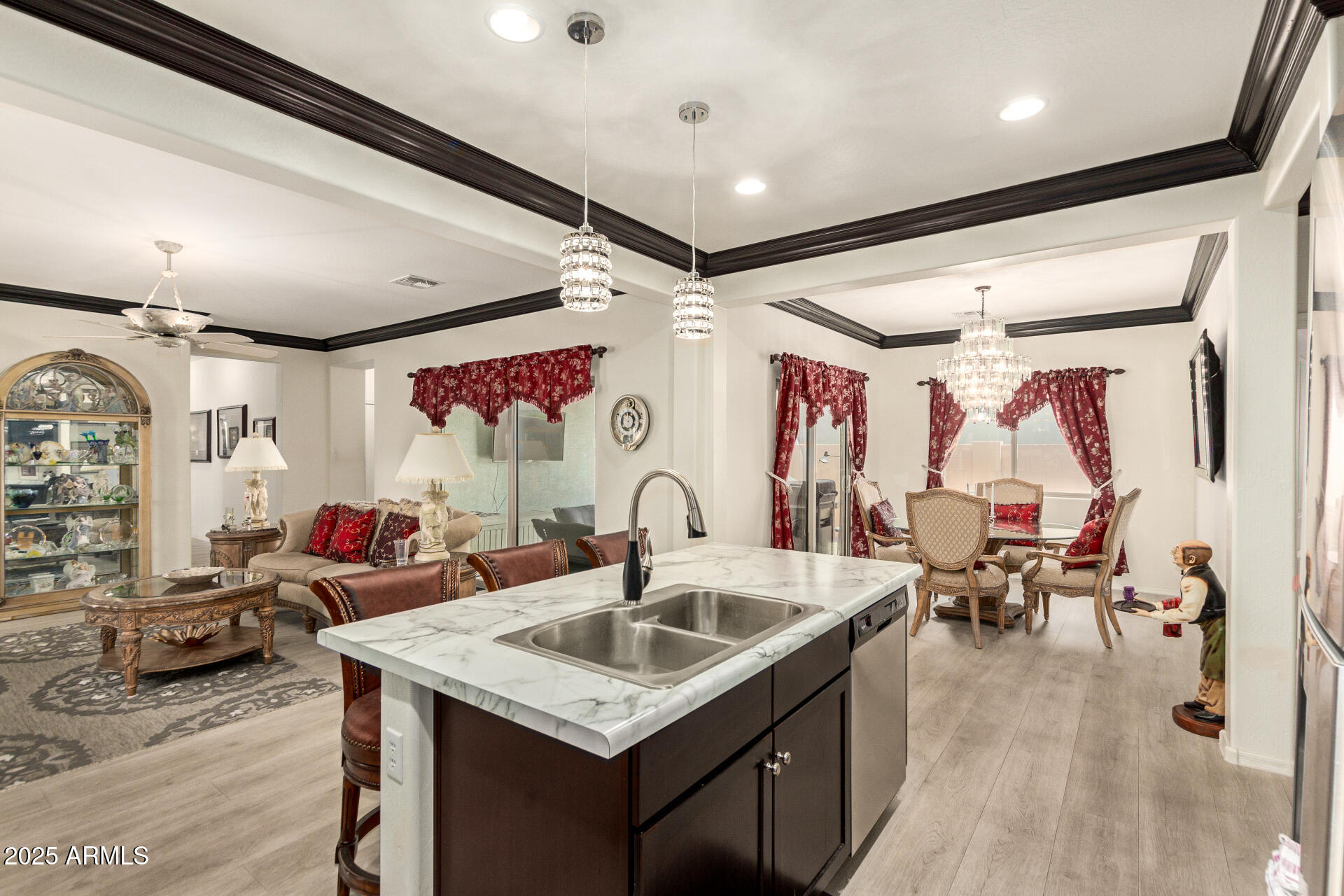 1616 South Aryelle Road Apache Junction, AZ 85119 - Photo 9 of 29 a kitchen island with stainless steel appliances kitchen island granite countertop a sink and wooden floors