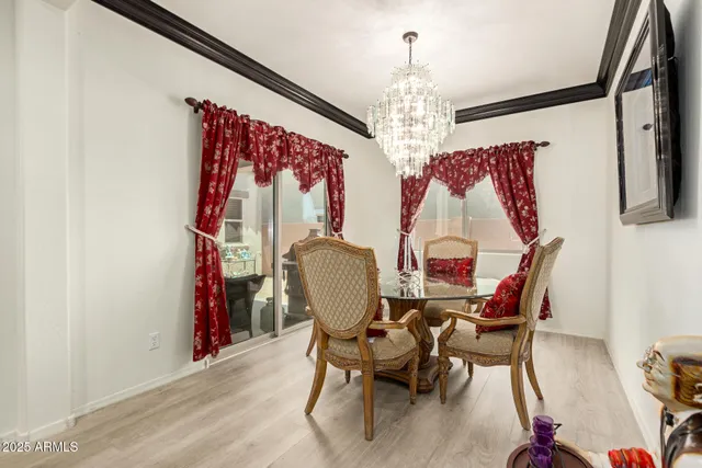 a view of a dining room with furniture chandelier and wooden floor