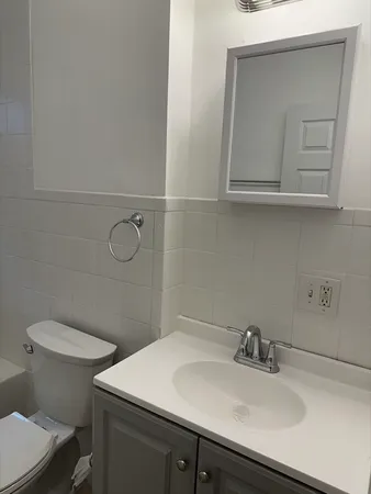 a bathroom with a sink toilet and vanity