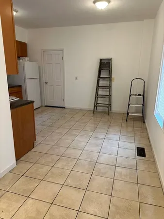 a view of a livingroom with wooden floor and furniture