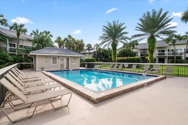 a view of a house with pool and sitting area