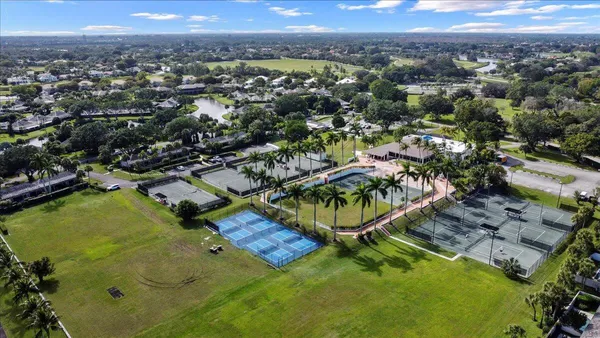 an aerial view of residential houses with outdoor space and swimming pool