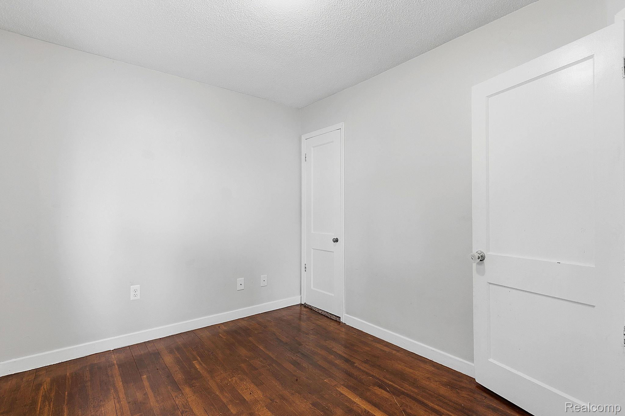 5852 Beech Daly Road Taylor, MI 48180 - Photo 18 of 29 Interior room with wood-finish flooring, light gray walls, and white trim