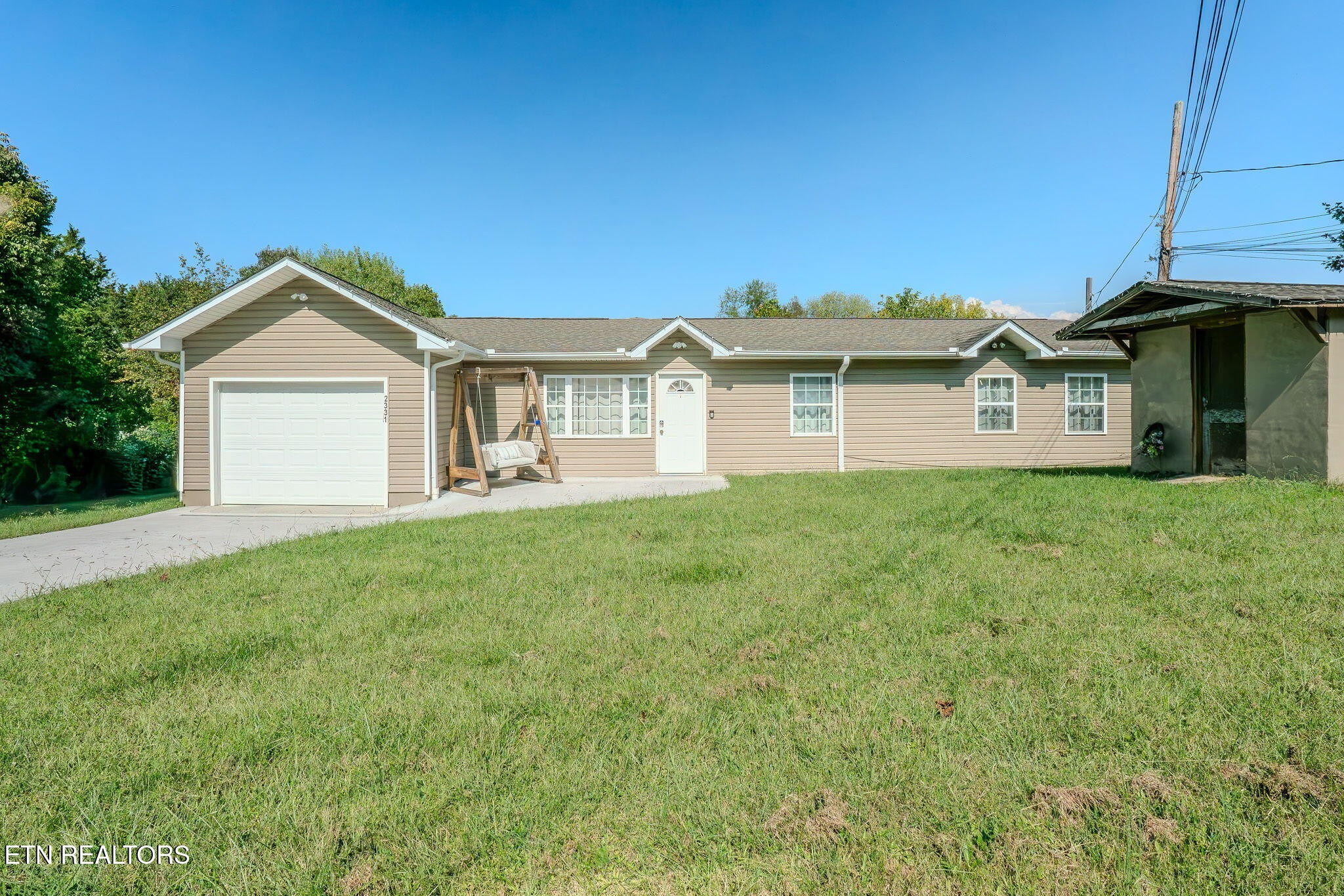 2331 Webb Road Sevierville, TN 37876 - Photo 1 of 23 a front view of a house with a garden and yard
