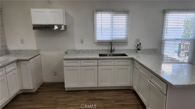 a kitchen with sink cabinets and window