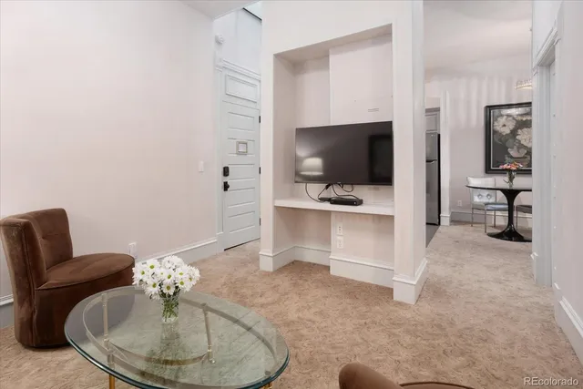 a living room with furniture and a ceiling fan
