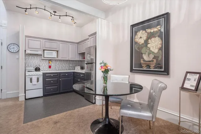 a kitchen with a refrigerator sink and cabinets