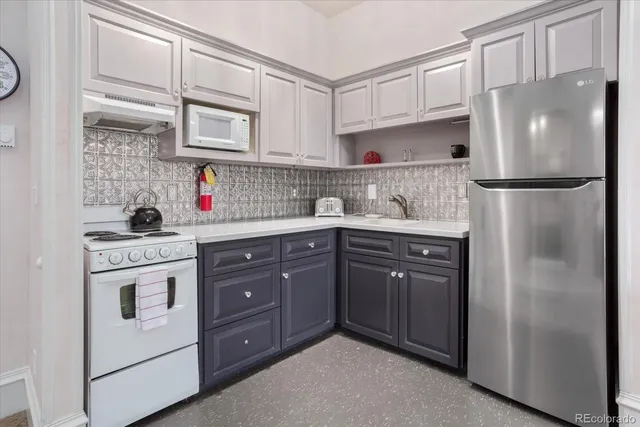 a kitchen with a sink a stove and cabinets