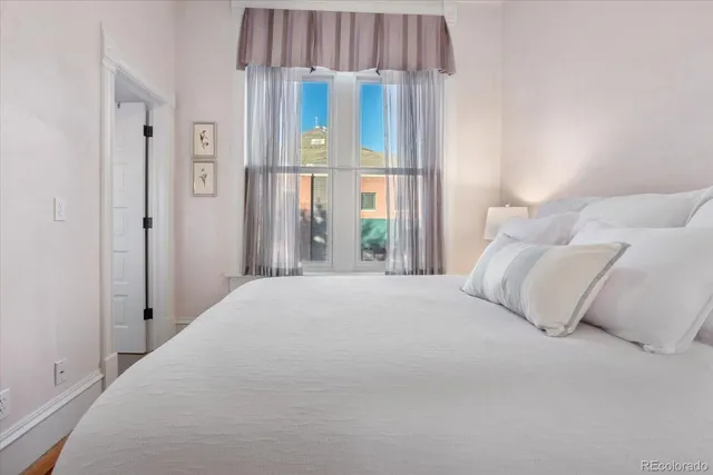 a bed room with a bed and a television