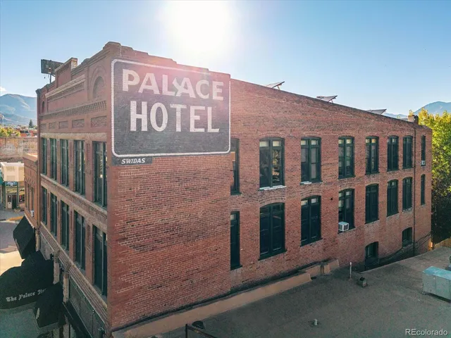 an aerial view of a balcony with chairs