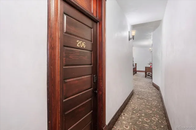 a living room with furniture and a lamp