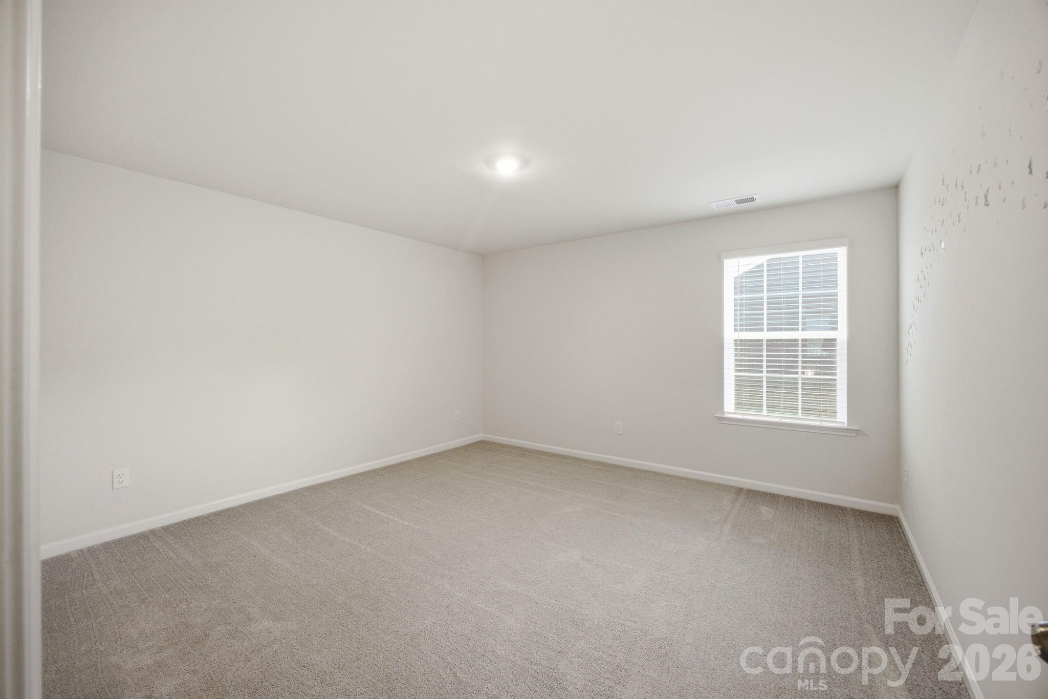 234 Hamptons Cove Road Troutman, NC 28166 - Photo 21 of 32 an empty room with a window