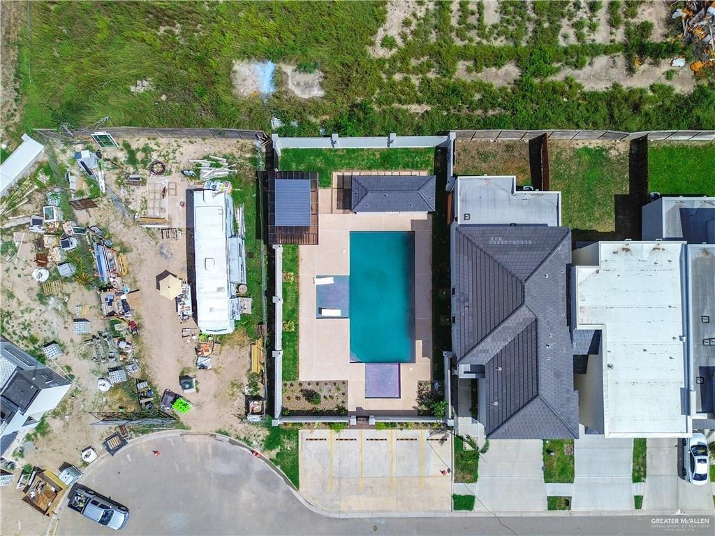 2206 Corales Street Mission, TX 78573 - Photo 23 of 23 Expansive rear yard featuring an in-ground swimming pool, surrounding patio, and a covered outdoor structure