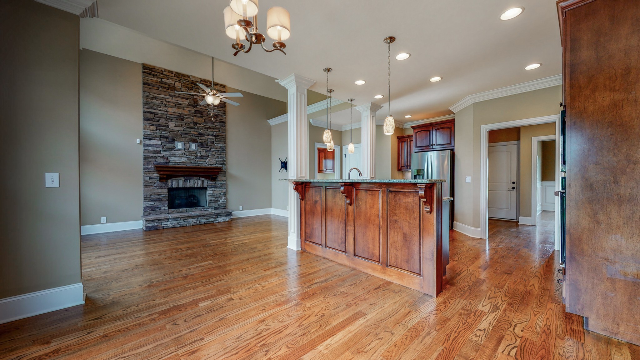 701 Stone Mill Circle Murfreesboro, TN 37130 - Photo 18 of 42 an empty room with wooden floor fireplace and windows