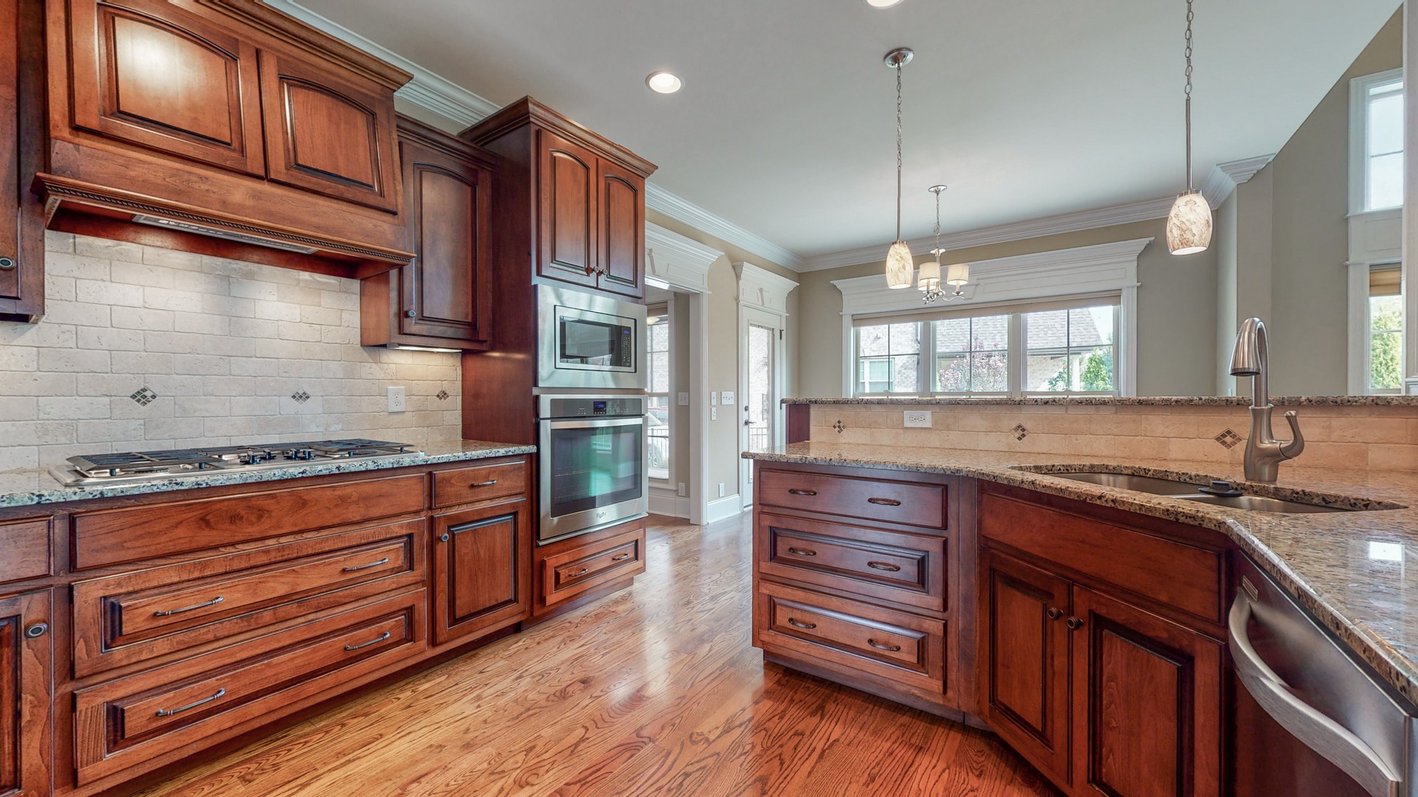 701 Stone Mill Circle Murfreesboro, TN 37130 - Photo 24 of 42 a kitchen with stainless steel appliances granite countertop wooden cabinets and a stove top oven