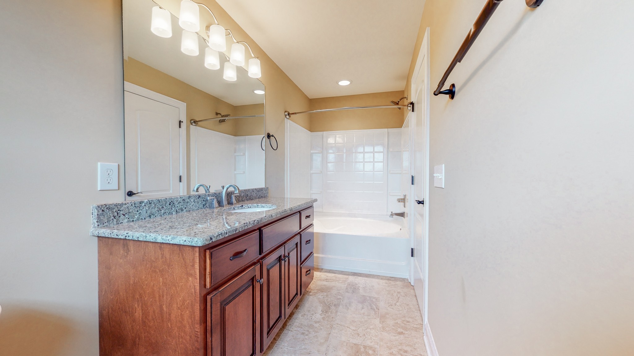701 Stone Mill Circle Murfreesboro, TN 37130 - Photo 32 of 42 a bathroom with a granite countertop sink a mirror and a bathtub