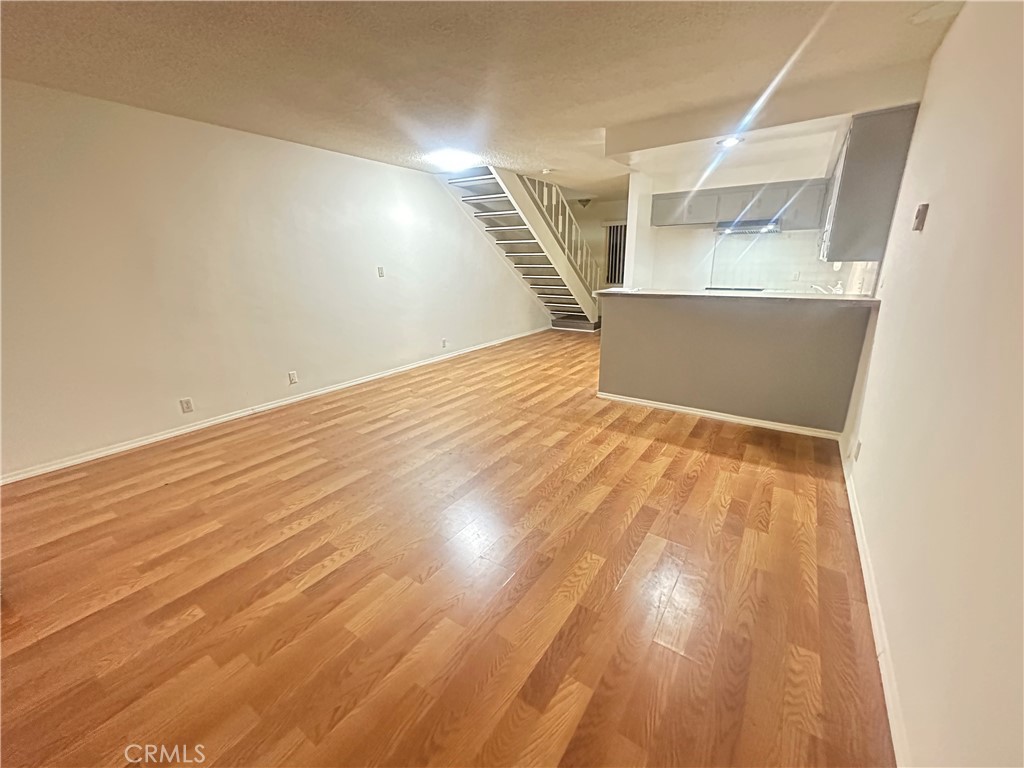 515 Fairview Avenue, Unit 8 Arcadia, CA 91007 - Photo 6 of 15 an empty room with wooden floor and windows