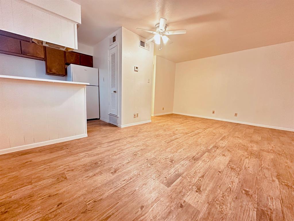 4204 Speedway, Unit 203 Austin, TX 78751 - Photo 2 of 10 Unfurnished living room with light wood-style flooring and ceiling fan
