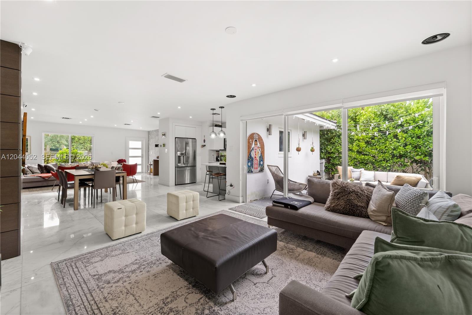 721 Bird Road Coral Gables, FL 33146 - Photo 5 of 24 a living room with furniture and a large window