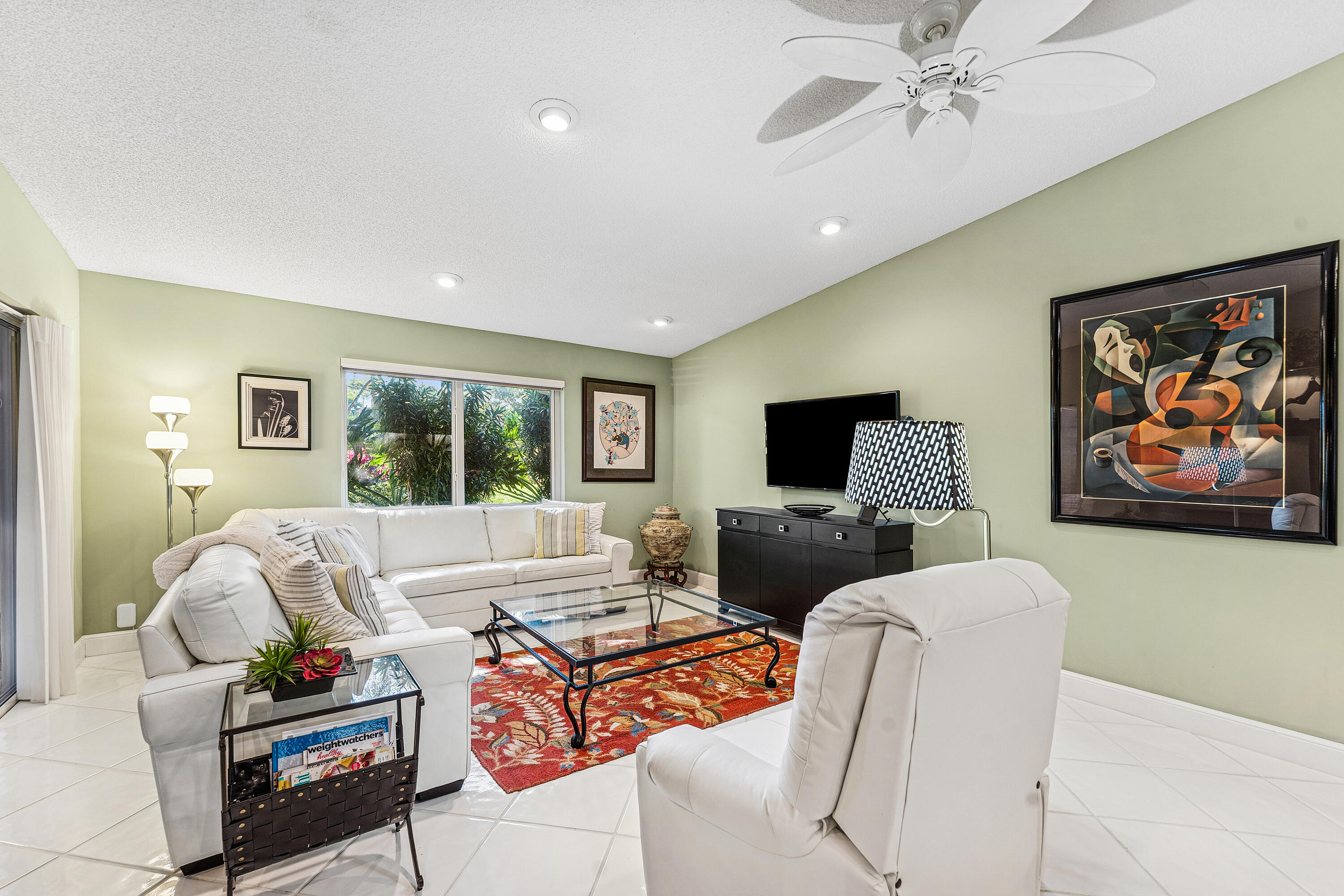 6348 Pointe Pleasant Circle Delray Beach, FL 33484 - Photo 12 of 40 a living room with furniture and a flat screen tv