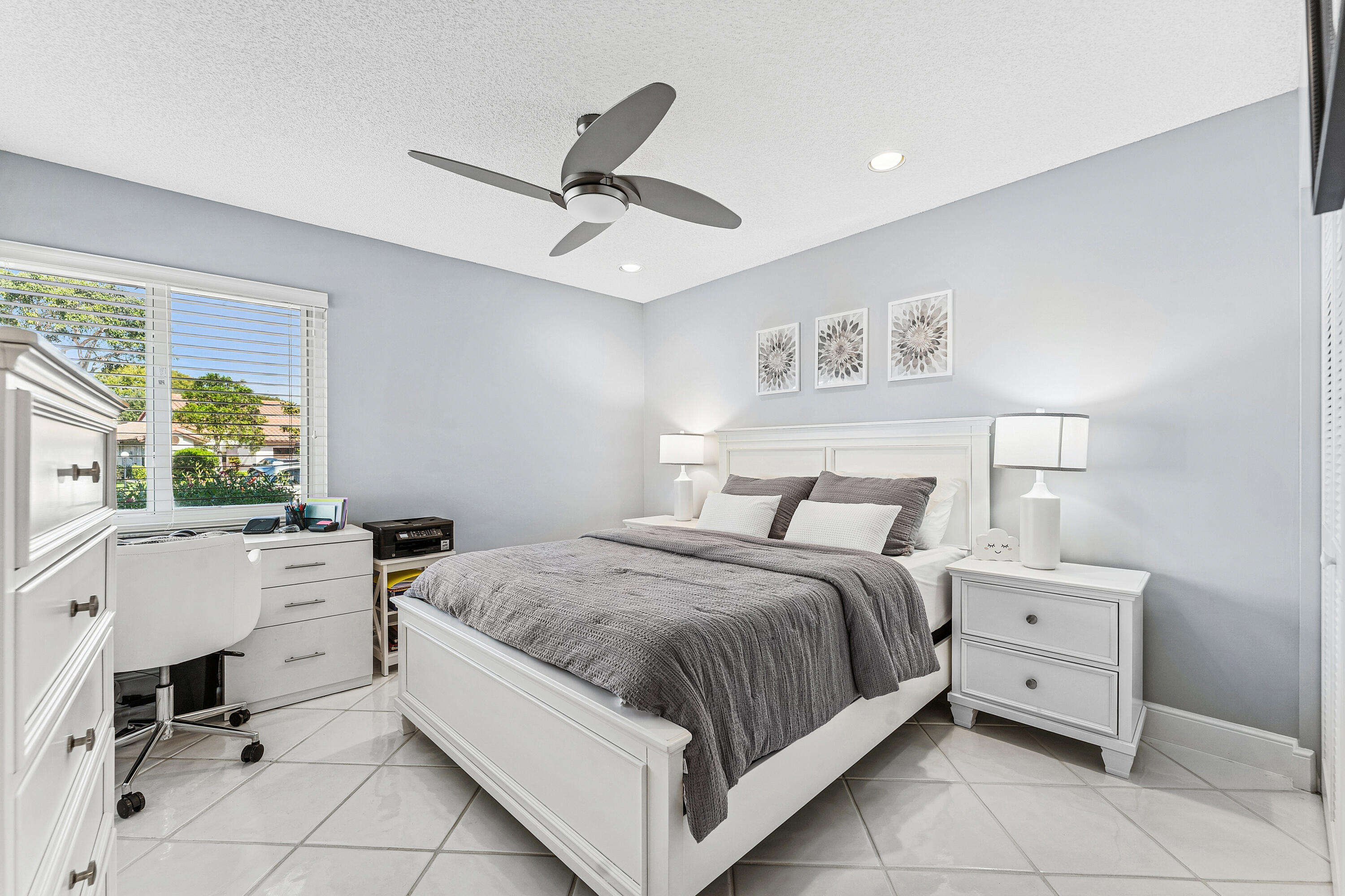 6348 Pointe Pleasant Circle Delray Beach, FL 33484 - Photo 14 of 40 a spacious bedroom with a bed and a table in it