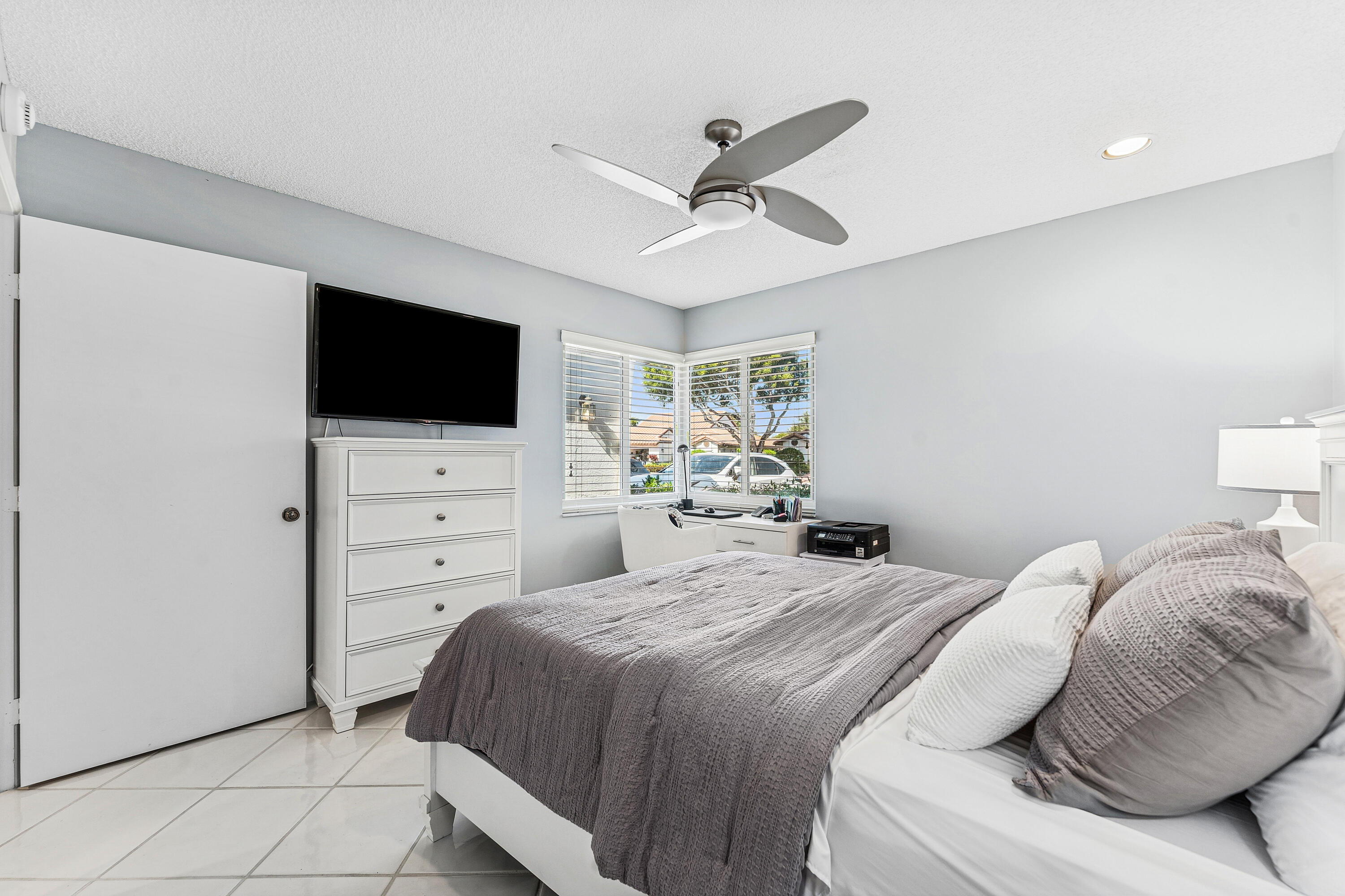 6348 Pointe Pleasant Circle Delray Beach, FL 33484 - Photo 15 of 40 a bedroom with a bed and a flat screen tv