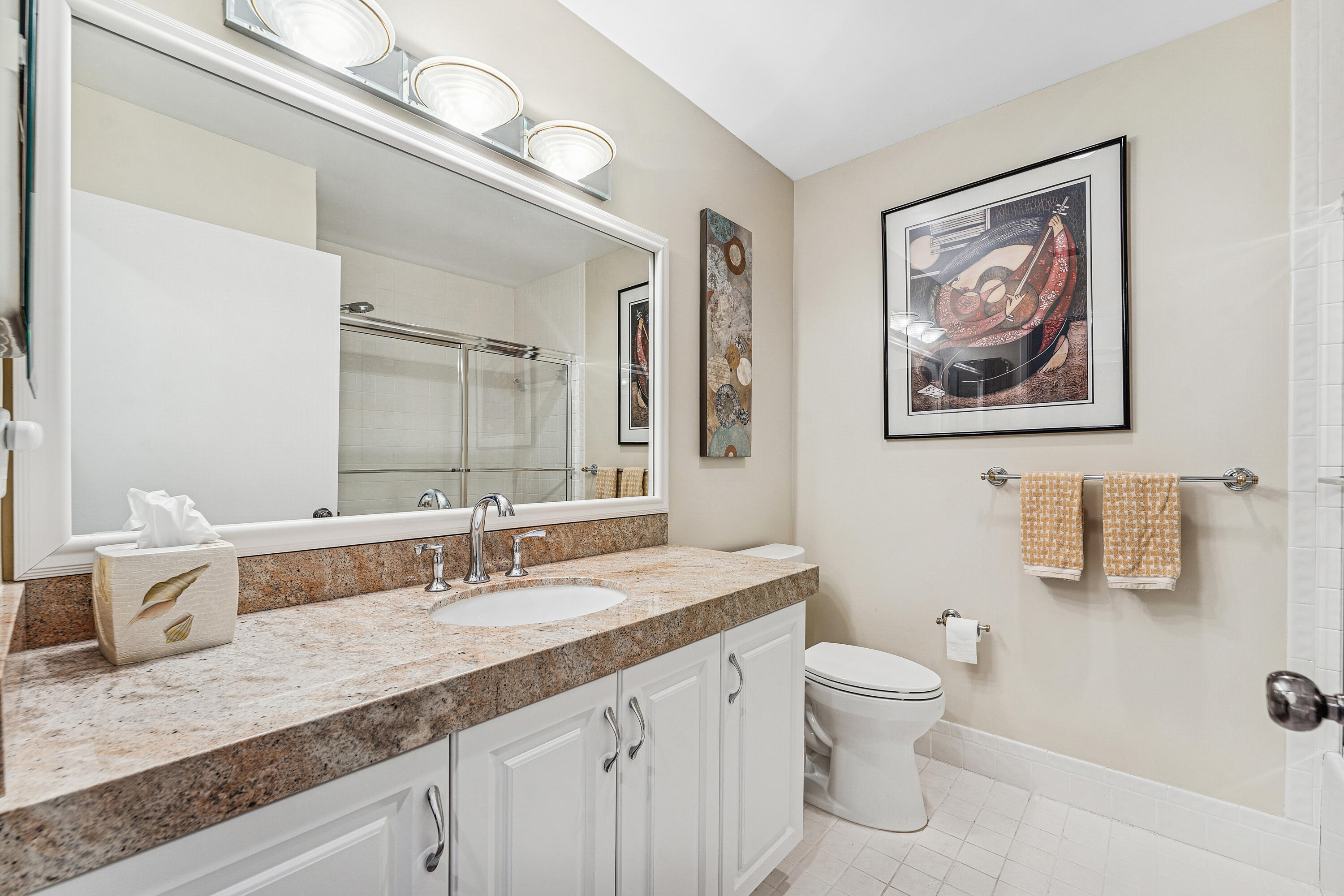 6348 Pointe Pleasant Circle Delray Beach, FL 33484 - Photo 16 of 40 a bathroom with a granite countertop sink a toilet and a mirror