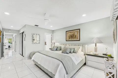 a bedroom with a large bed and a lamp