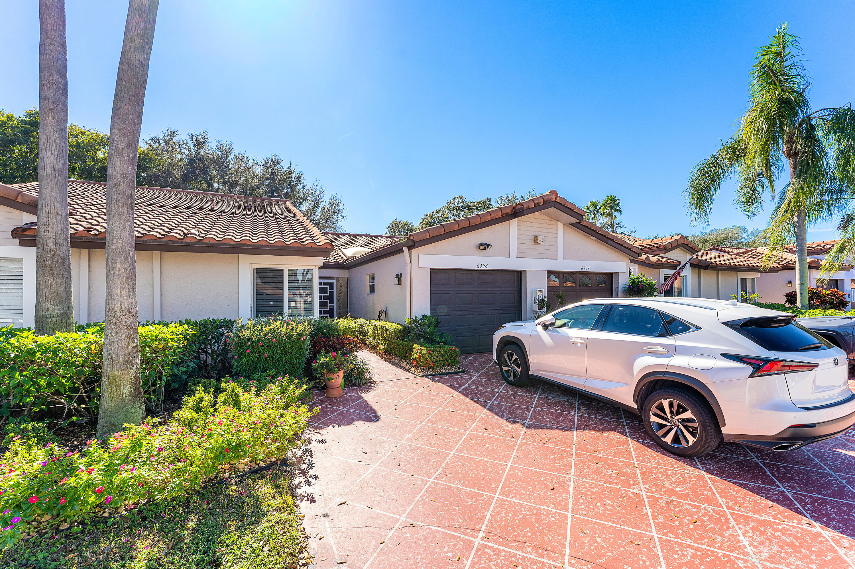 6348 Pointe Pleasant Circle Delray Beach, FL 33484 - Photo 2 of 40 a front view of a house with a garden
