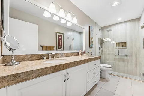a bathroom with a double vanity sink and a mirror