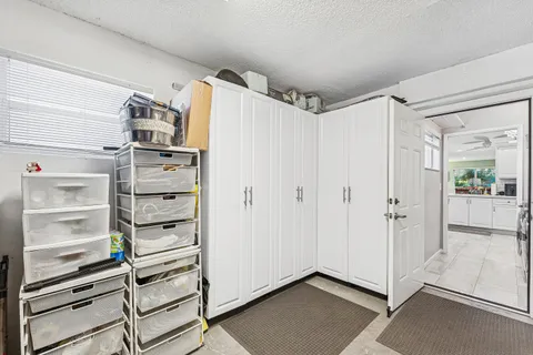 a view of washer and dryer with kitchen in the background